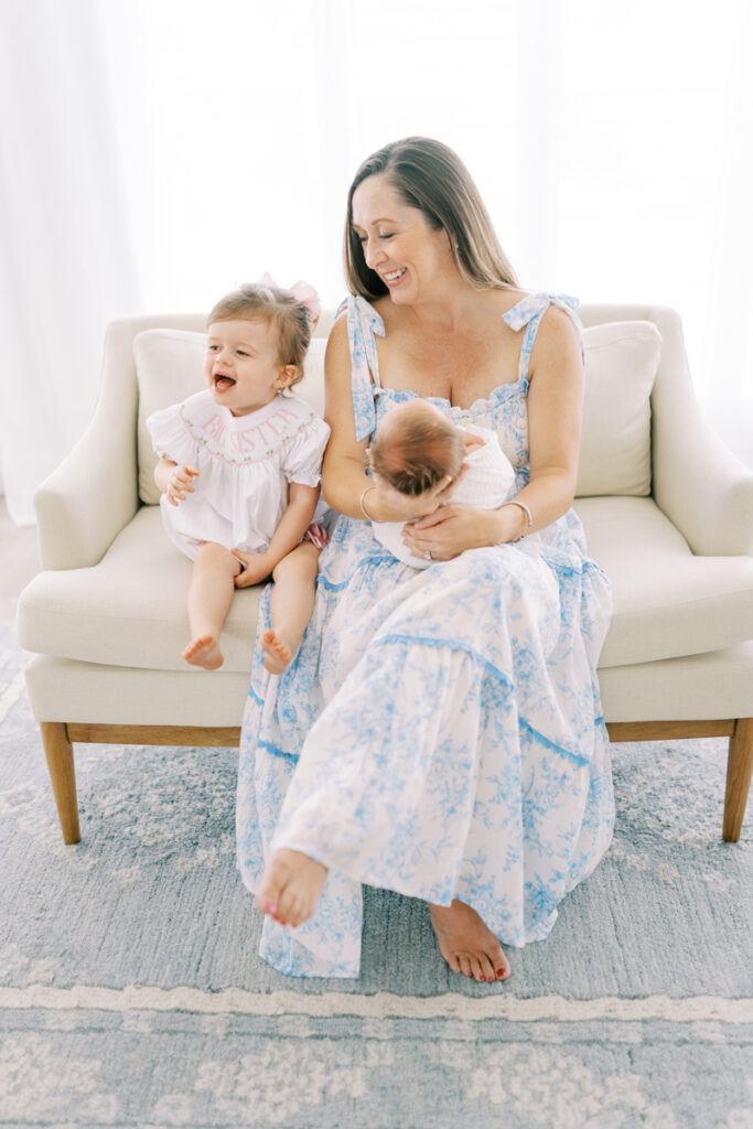 Toddler laughing during newborn session