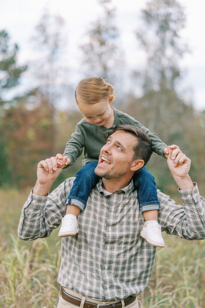 dad holding small son on shoulders